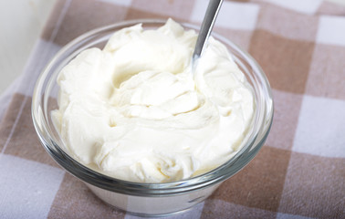 Fresh strained yogurt in bowl. Close up. 