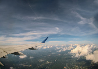 Fototapeta na wymiar Aerial view of cloud and sky with airplane wing from window
