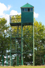 Old metal watchtower at a forest edge