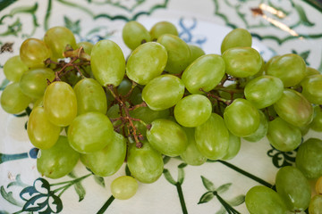 Plate with green grapes bunch, close-up. Fresh grape