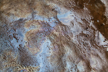 Oil slick on asphalt texture background