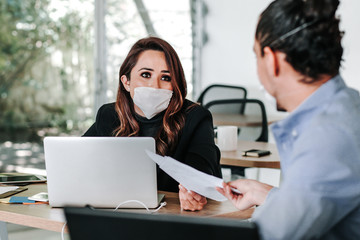 latin people teamwork with face mask at office or workplace in Mexico pandemic coronavirus