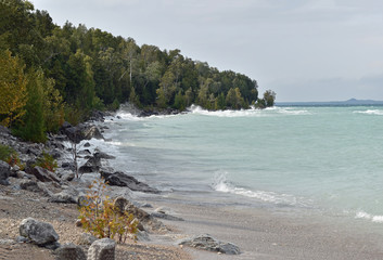 Forest reaches the water on the east side of Mackinac Island on Lake Huron