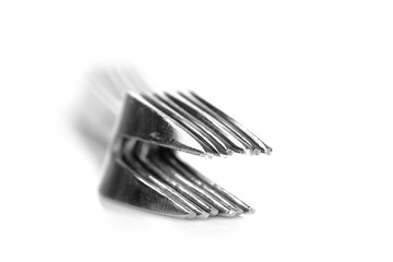 Stack small fruit eating forks on white background