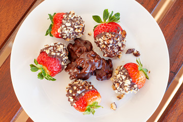 Breakfast bowl with quinoa, banana, coconut, cocoa, walnuts served on wooden table