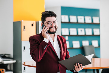Latin young business man talking on phone at office in Mexico