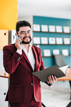 Latin young business man talking on phone at office in Mexico