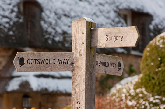 Cotswold Way Signpost In Front  Thatched Cottage In Winter Snow In Chipping Campden. Gloucestershire. England.