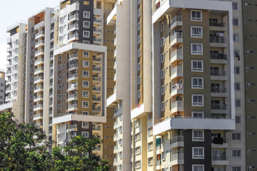 Bangalore, Karnataka, India - December,12, 2015: A high rise modern apartment complex in suburban Bangalore against a blue sky on a sunny day. © SNEHIT PHOTO