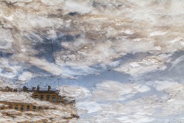 Vintage apartment house reflected in freezing Fontanka river