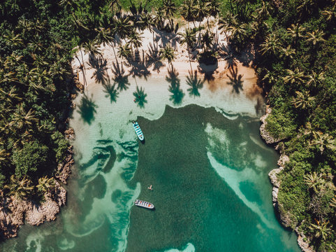 Aerial drone view of intimate paradise beach with blue lagoon and palm trees at the Madama beach, Samana, Dominican Republic
