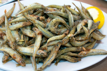fried sand smelt fishes or Atherina on a white plate