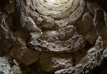 An old stone well from inside. Picture taken from below. 
