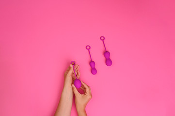 woman holds a kegel trainer. Latex vaginal vibrator for training the pelvic floor muscles with an antenna. The device for imbuilding. Women Health. High quality . Copy space. Banner