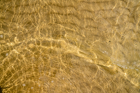 High angle view of sand through clean and clear water