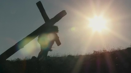 Jesus with crown of thorns carrying a heavy cross