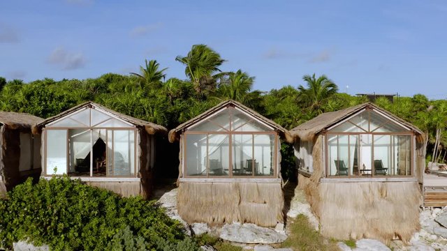 Aerial view of beautiful and unique guest houses at exclusive beachfront resort in Mexico