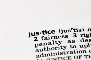Dictionary definition of the word justice in focus. Concept of punishment, judicial and legal...