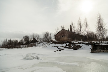 Winter landscape with old abandoned barrack