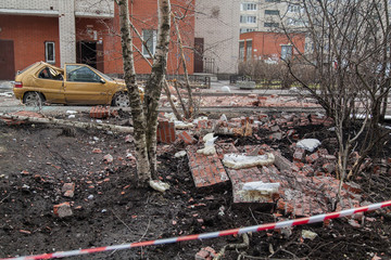A pile of broken bricks and a destroyed car at the site of the collapse of the wall of a...