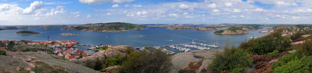 Fototapeta na wymiar Panoramic View From From Vetteberget Hill To Skerry Islands Around Fjallbacka On A Sunny Summer Day With Some Clouds In The Sky