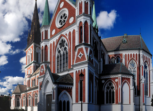 Red-White Coloured Sofia Cathedral In Jonkoping On A Sunny Summer Day With Some Clouds In The Sky