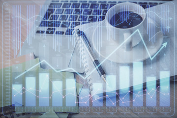 Double exposure of forex chart drawing and desktop with coffee and items on table background. Concept of financial market trading