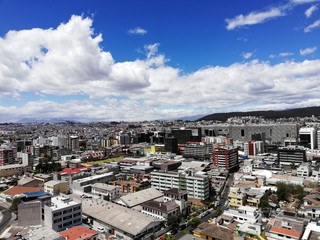 Naklejka premium View from the top of the north of the city of Quito, you can see buildings, mountains, the sky and clouds