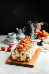 meringua roullade, roll with cream and fresh strawberries
