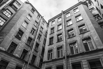 The courtyard of an old apartment building in St. Petersburg with yellow shabby walls