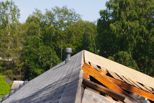 old roof renovation, frame of the roof covered with wooden OSB boards