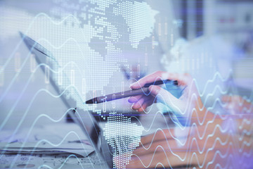 Multi exposure of woman hands typing on computer and financial graph hologram drawing. Stock market analysis concept.
