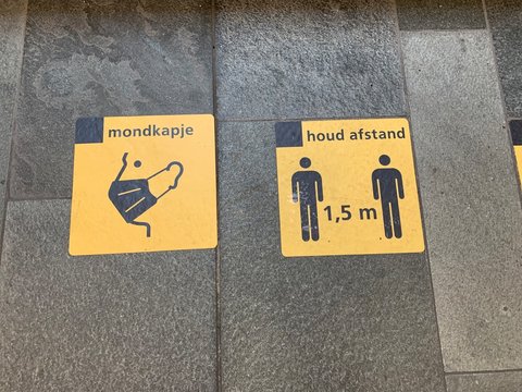 1,5 meter social distancing ( houd afstand) and mandatory face masks ( mondkapje) wearing signs at Eindhoven Centraal train station. Eindhoven, North Brabant / Netherlands.