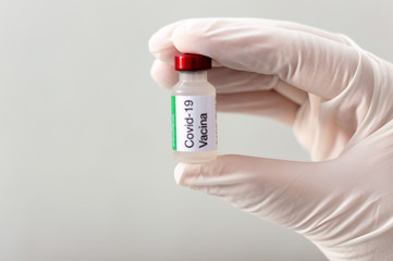 Scientist holding covid vaccine bottle