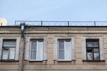 Shabby windows of old apartment buildings in St. Petersburg
