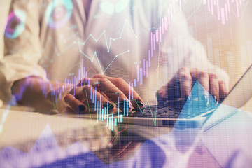Double exposure of woman hands typing on computer and forex chart hologram drawing. Stock market invest concept.