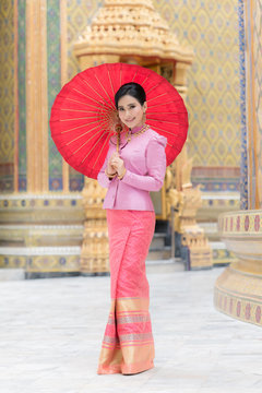 Beautiful girl in pink Thai dress.