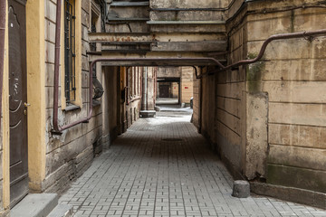 Arch in the entrance courtyard of an old apartment building in St. Petersburg