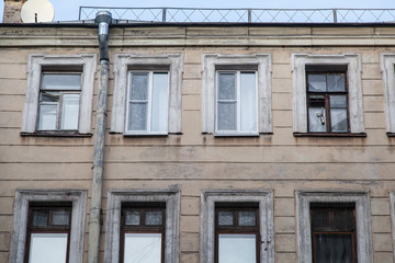 Shabby windows of old apartment buildings in St. Petersburg