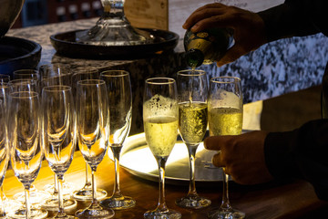Pouring sparkling wine into a glass in a restaurant