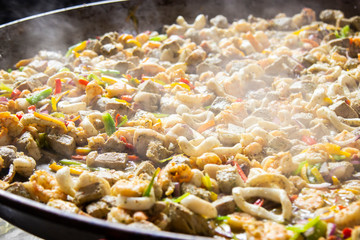 Traditional spanish paella with seafood and pork. Prepared