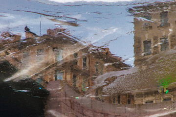 Vintage apartment house reflected in Fontanka river in time of ice drift