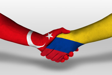 Handshake between columbia and turkey flags painted on hands, illustration with clipping path.