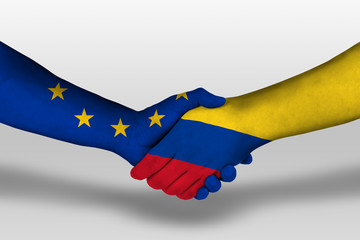 Handshake between columbia and european union flags painted on hands, illustration with clipping path.