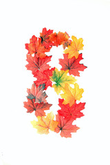 Alpha numeric sets of numbers 0 to 9 and letters A to Z made  using fall leafs, artificial type of rich autumn color, red, orange, golden earth tones, convey ot is in nature fall colors and style.