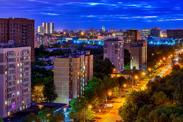 Obraz premium Night street in lights with blue sky and yellow road