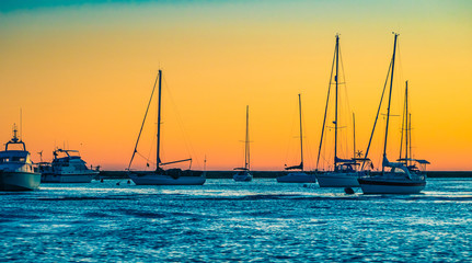 Sailboats in Faro's Beach on sunset