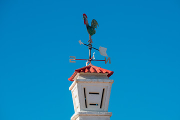 Fototapeta na wymiar Portuguese cock on toPortuguese cock on top of the chimneyp of the chimney