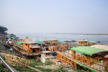 Fototapeta na wymiar Big river tour and local traditional boats in rural area, Myanmar, Burma