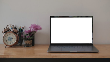 Blank screen Laptop computer and poster workspace background in modern office..